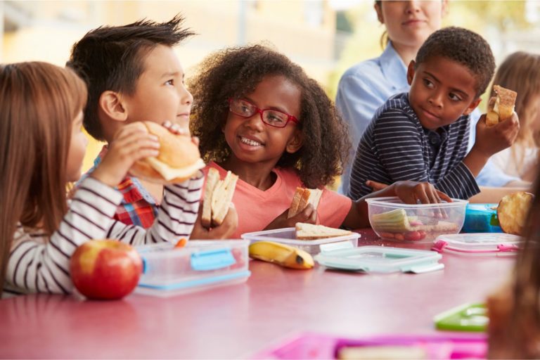 Children eating lunch, putting them at risk for anaphylaxis